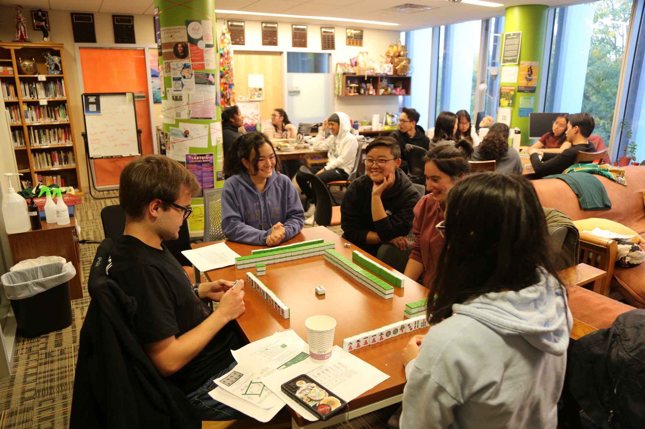 Students playing Mahjong around a table